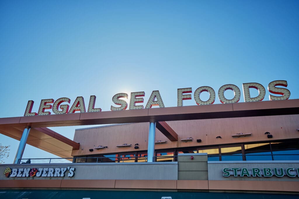 A storefront under a clear blue sky with a sign reading 